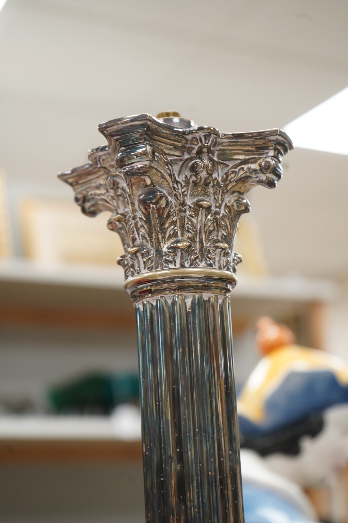 A Corinthian column silver plated lamp with stepped base, 50cm high